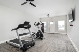 workout room with exercise equipment looking at windows in the ellingsworth commons clubhouse