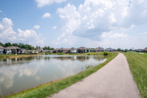 lake in the ellingsworth commons community with walking trail and houses