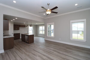 Open living area with ceiling fan and view of the kitchen | Homes in Southern Indiana