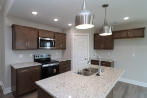 View of kitchen with island in the Maria floor plan | Homes in Southern Indiana